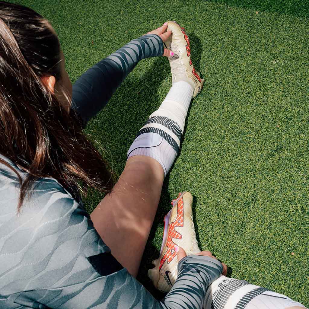 SOQA Tibia flexible football shin guards worn by a female player on the pitch